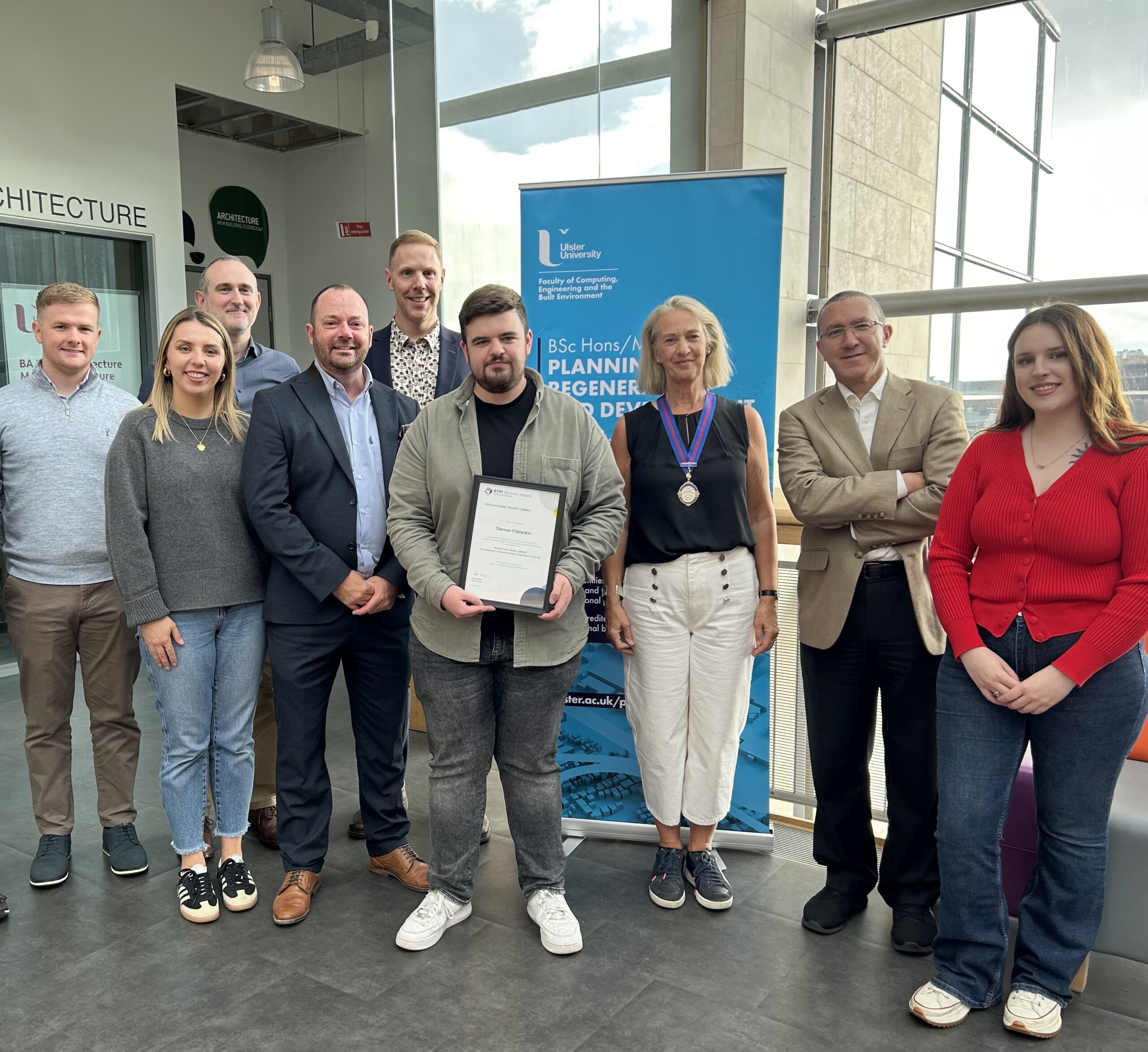 Carlin Planning employee with his certificate and other RTPI members.